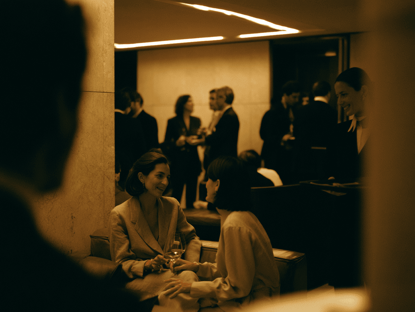 Members mingling at a busy evening reception