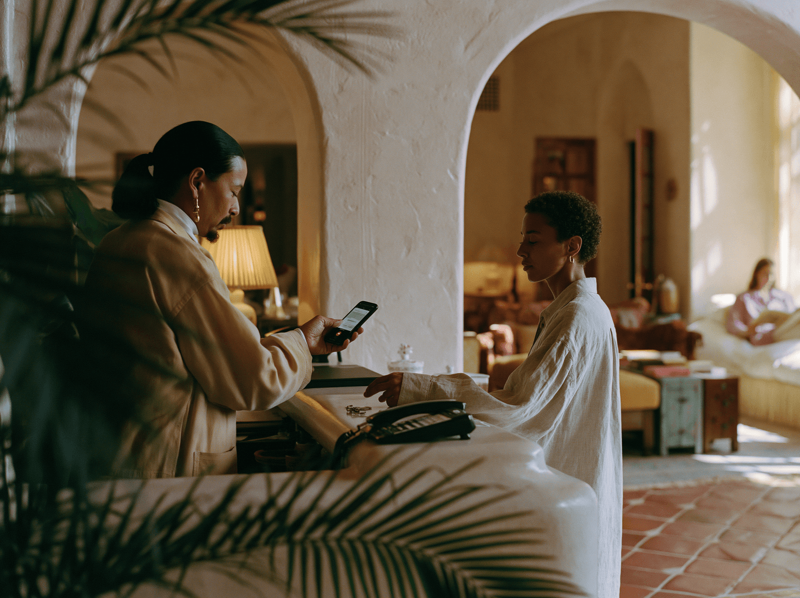 Reception team welcoming guests beneath an arched entry