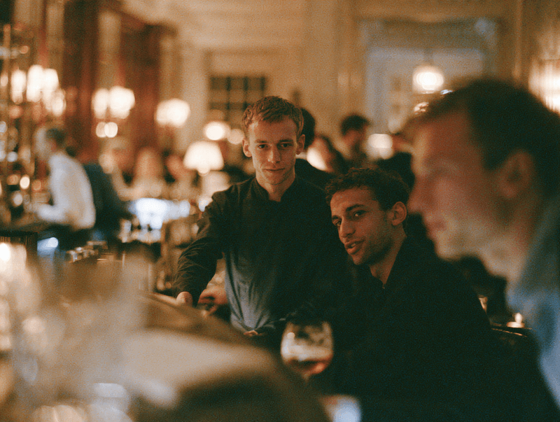 Members mingling at a lively club bar