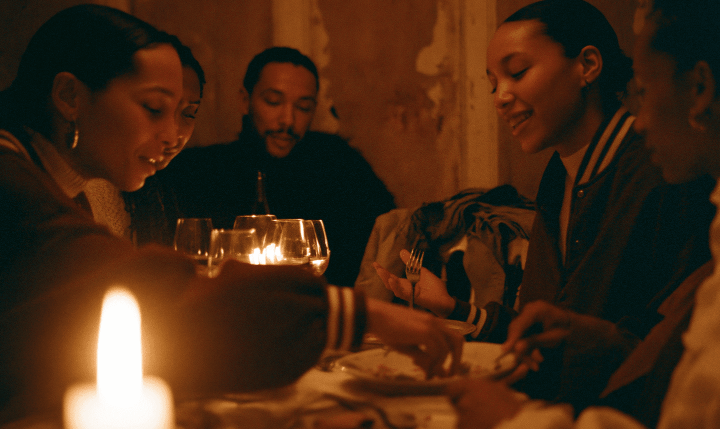 Members sharing a candlelit dinner together