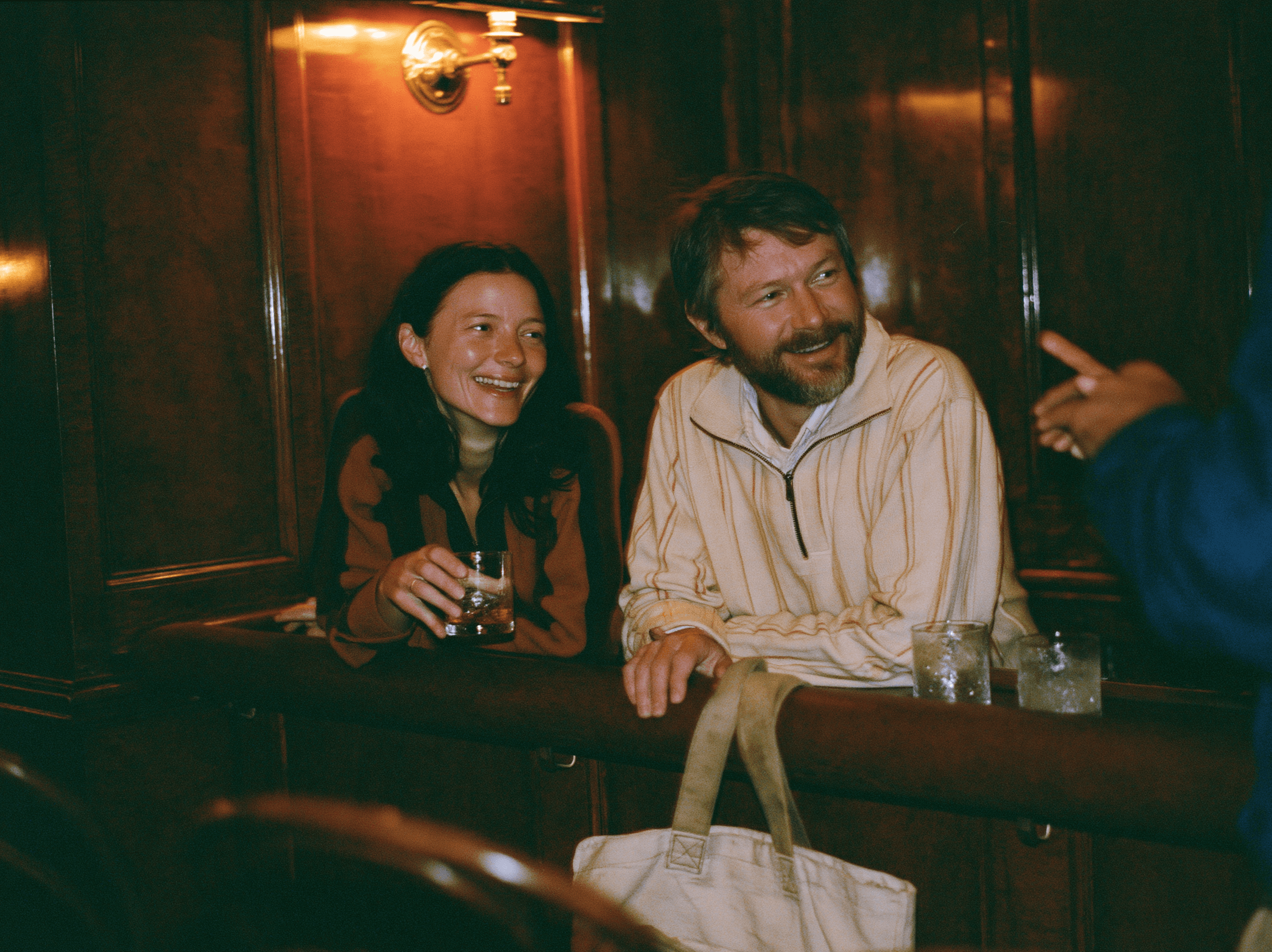 Members talking in a wood-panelled club booth