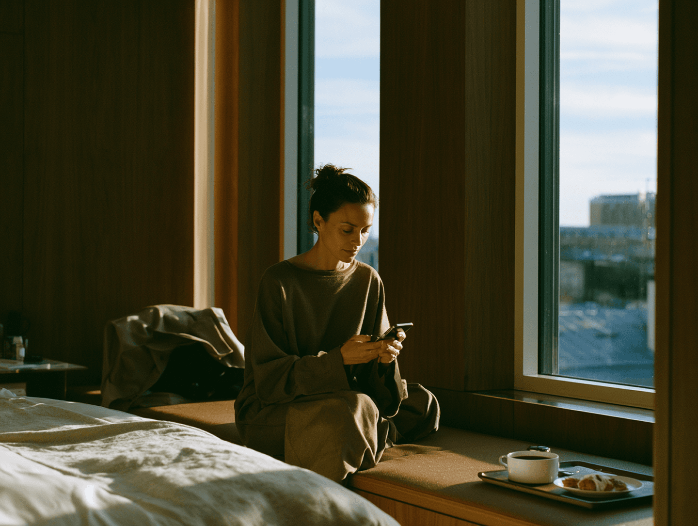 A resident at breakfast beside a floor-to-ceiling window