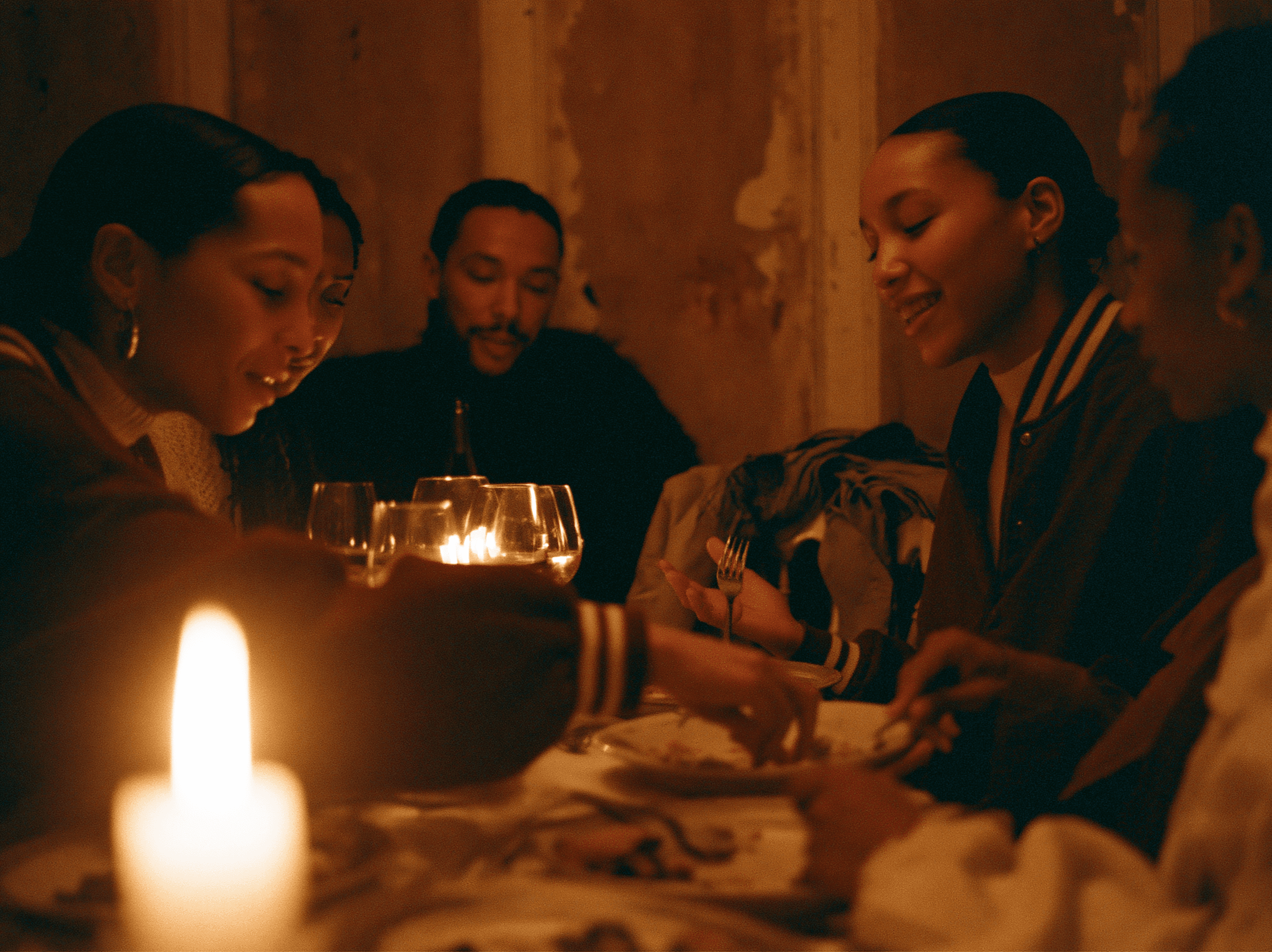 Guests sharing a candlelit dinner at an independent club