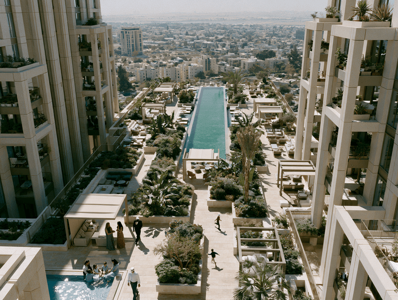 City skyline with a rooftop pool connecting residential towers
