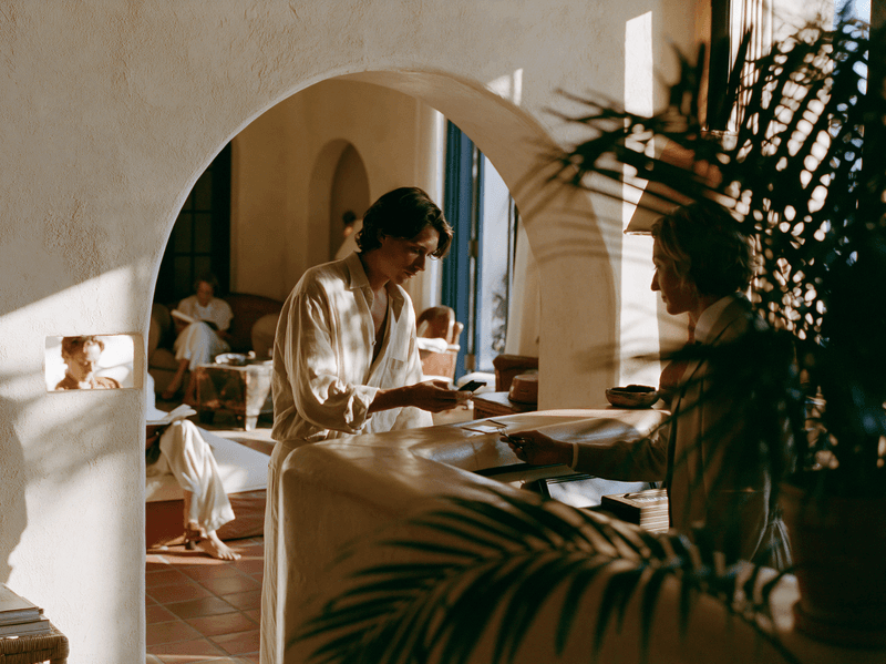 Guests dining beneath an arched courtyard doorway