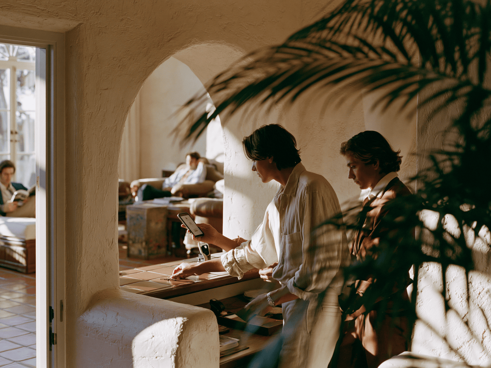 Team welcoming new members under an arched doorway