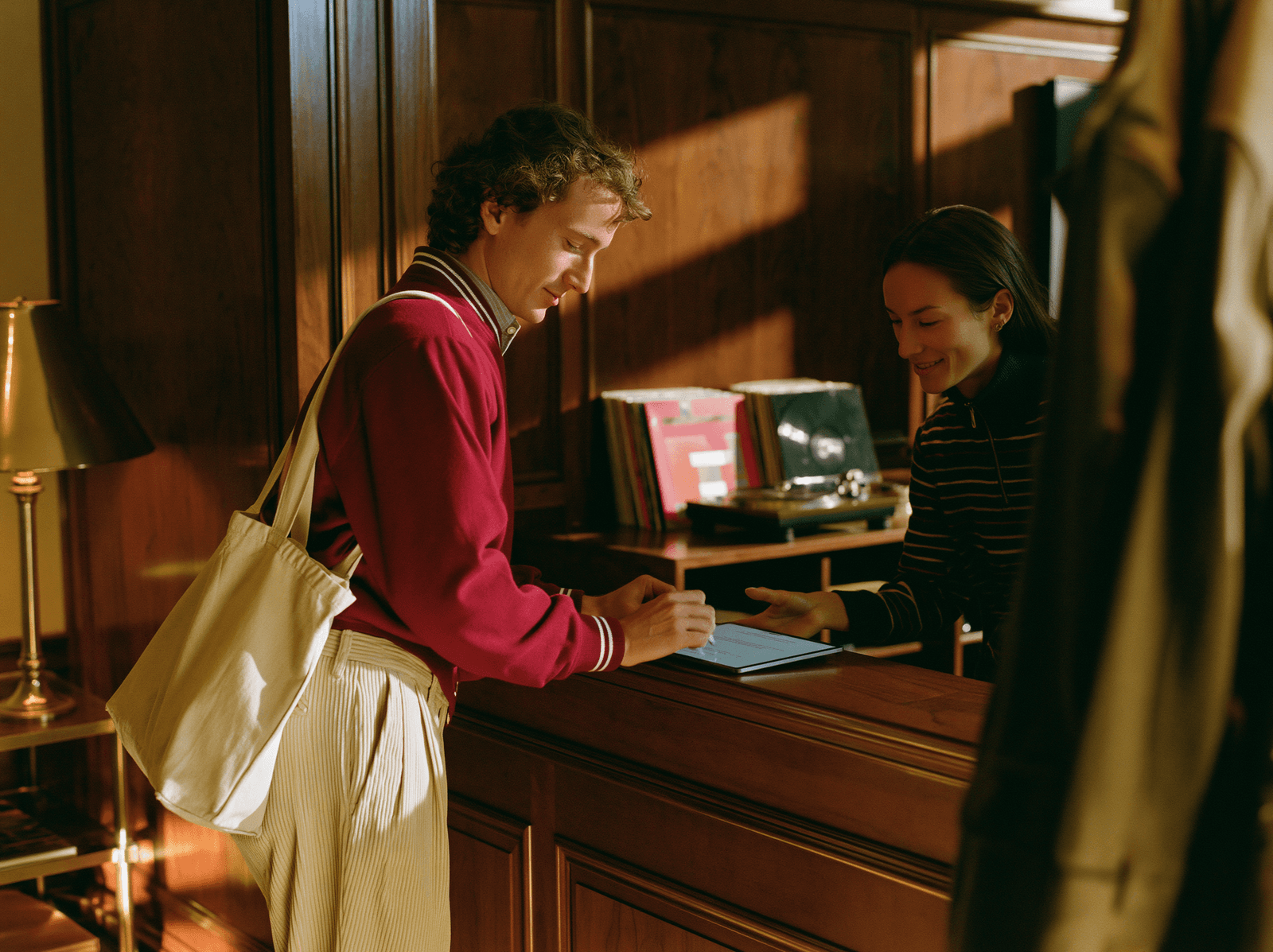 Prospective member signing an application at the front desk