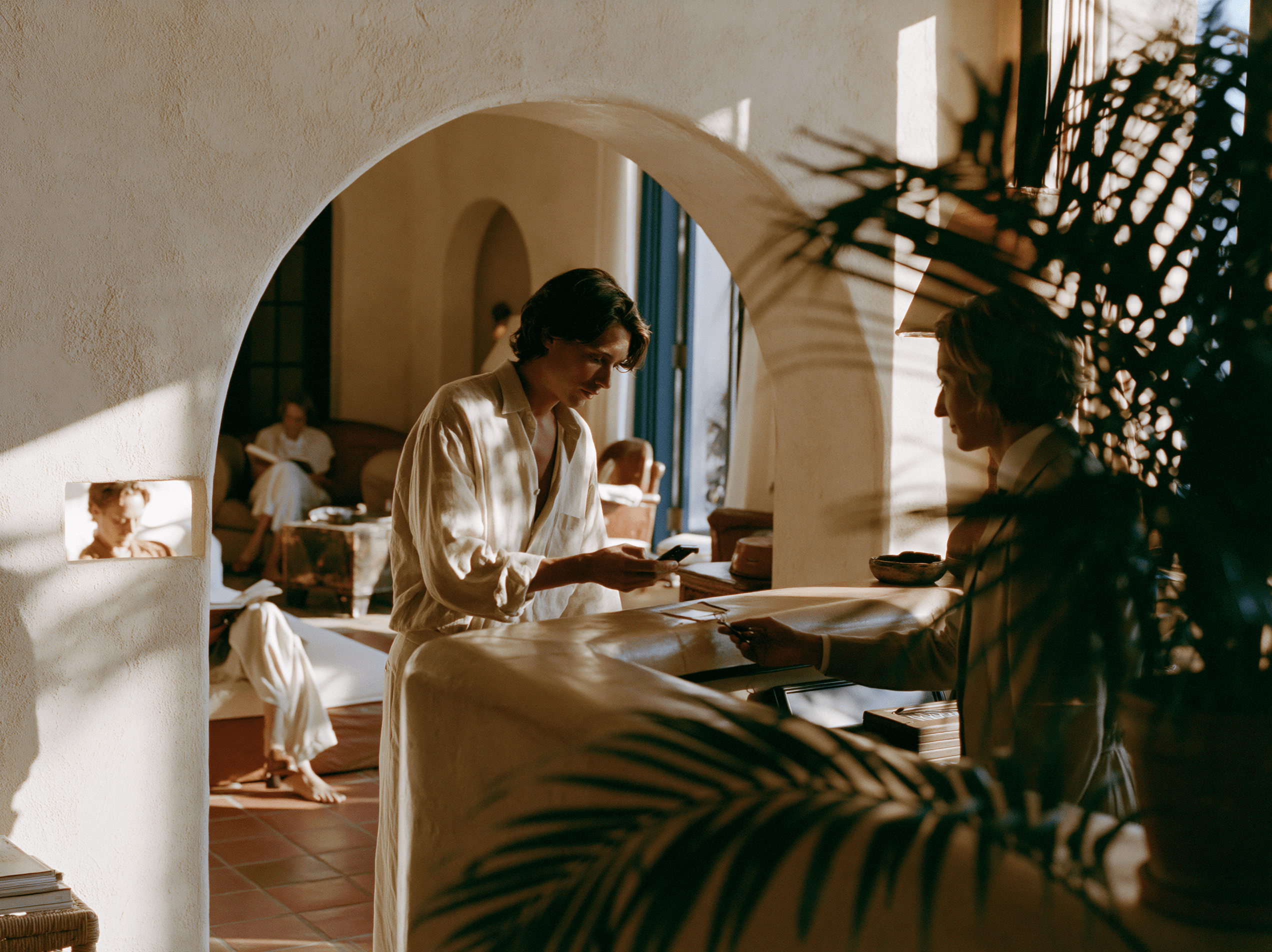 A member checking in at a beach club reception