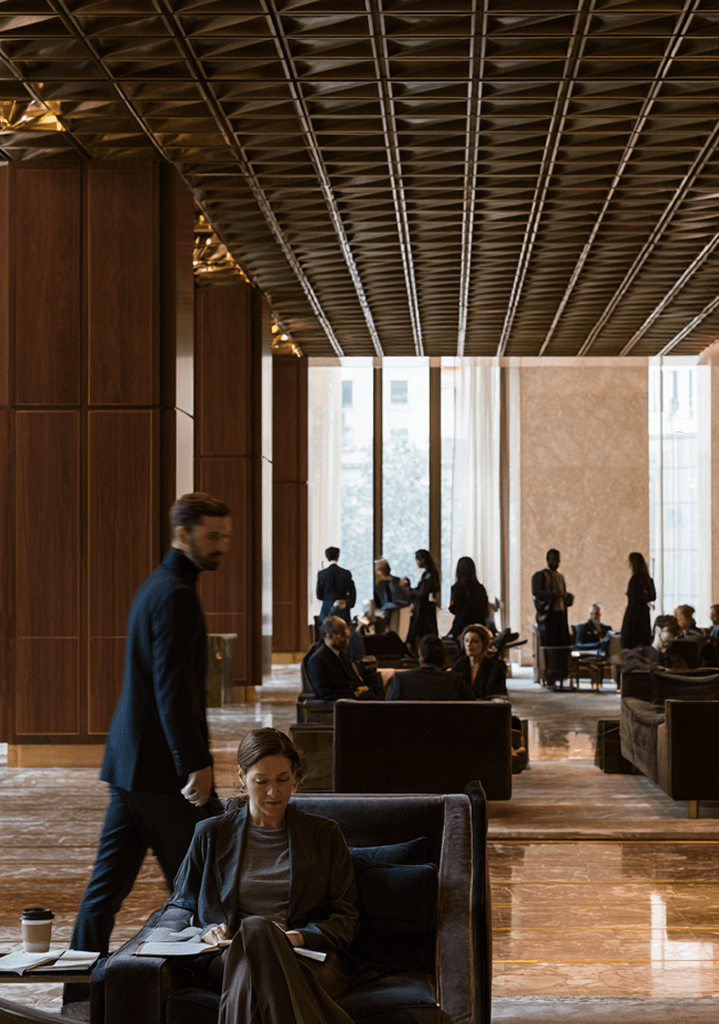 Members crossing a sunlit private club lobby