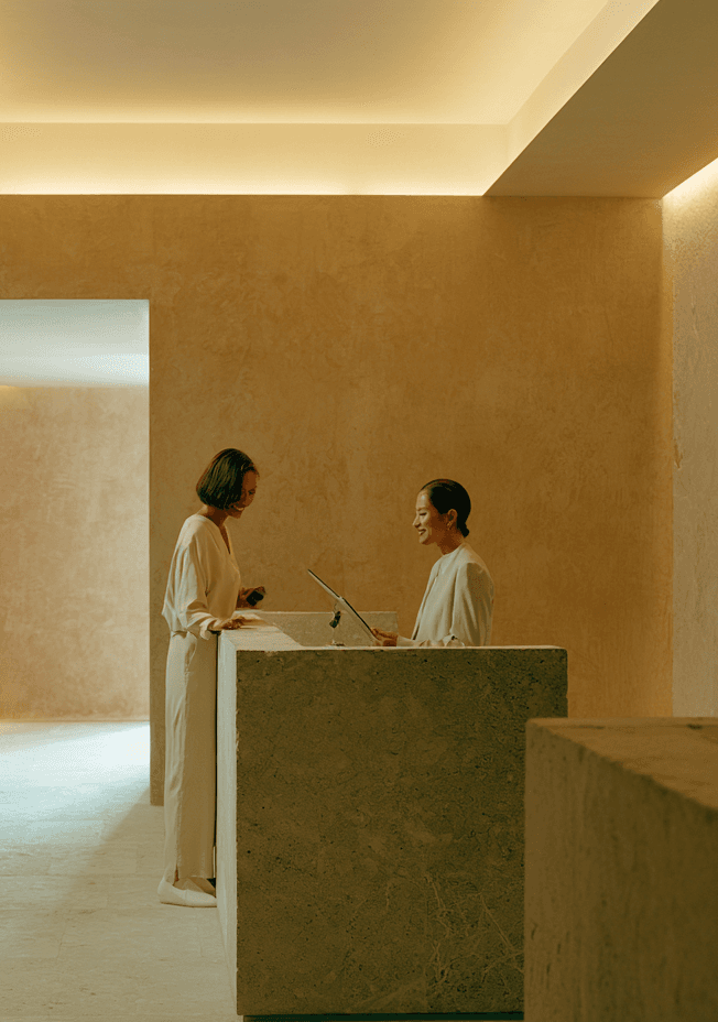 Members crossing a sunlit private club lobby